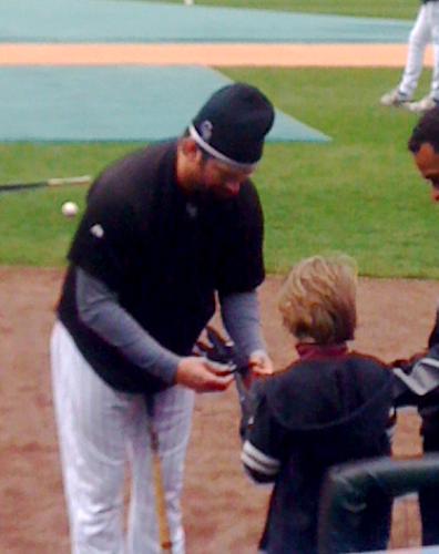 #17-Todd Helton of the Colorado Rockies putting his batting gloves on Klaus--a gift from Make a Wish