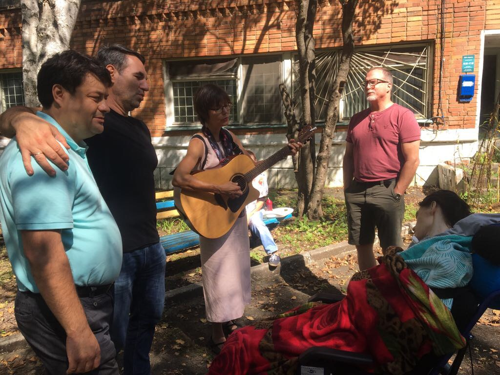 "Speak to one another with psalms, hymns and spiritual songs." (Ephesians 5:19) L-R, Denis Artyukin, Ruslan Magamedov, Tammy and Andy Fleming sing the songs of the church to Vika as Denis' mother takes a much-needed break on the bench nearby. September 2018. 