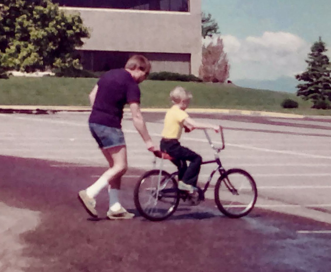 John teaching Neil how to ride  - Centennial CO 1982