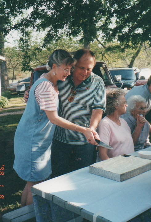 McLouth, April 2001--cutting the cake (after two of the sisters-in-law had already helped themselves to a piece not realizing that we were intended to cut it first!)