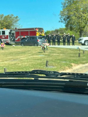 Engine&#x20;14&#x20;who&#x20;fought&#x20;the&#x20;fire&#x20;saluting&#x20;at&#x20;the&#x20;cemetery.&#x20;