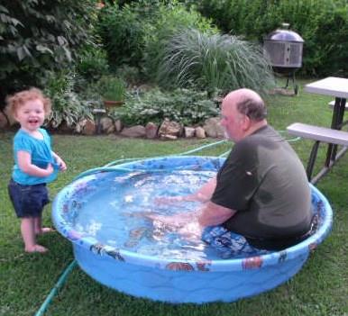 Trying to coax Kensley into the pool.  Jokes on you Poppy!