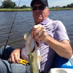 Dad catching all the fish while I peddled him around in my little boat.