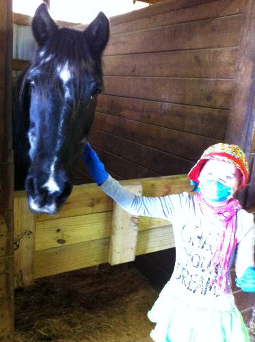 Maya visits her pony, Mimi.