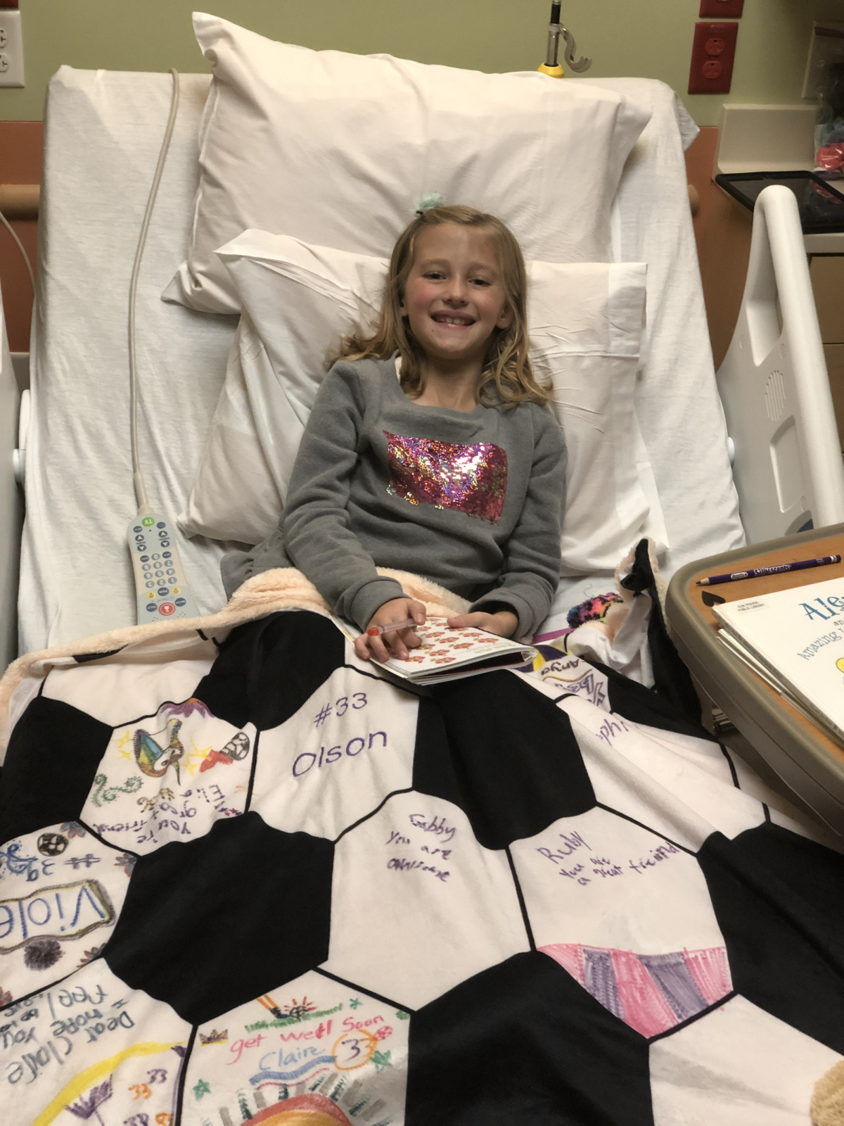 She's so brave with the help of her signed blanket from her soccer team! 