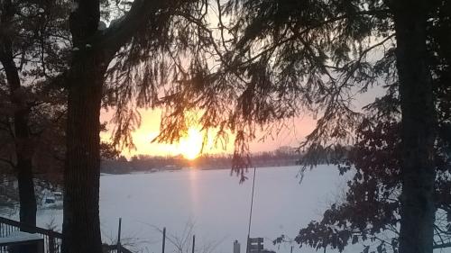Sunrise this morning, ice and snow now covering the lake.
