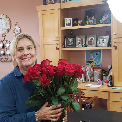 Me with 2 doz roses given to me by my husband on my 66th birthday!