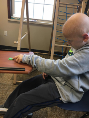 In OT Conner enjoyed playing a frog game where he flicked plastic frogs into a pond. He played with that most of the time making it more challenging.