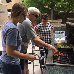 Such a great picture Linda Weider posted of Doug cooking hot dogs with Maddie, his PT and Ruby, his OT. Lookin' good!