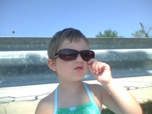 Erin was sitting pretty while Annie was at her swim lesson.  She needed Mom's shades for the sun. 08