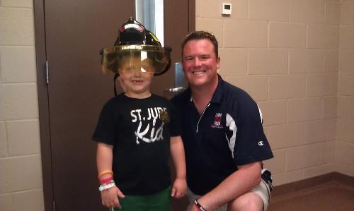 Carson trying on Joe's most awesome fire helmet.