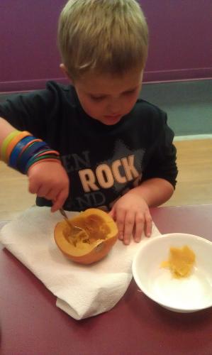 Carson digging out pumpkin for our homemade pumpkin bread.