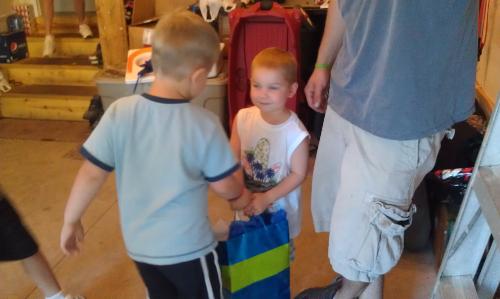 Carson giving the iPad to Colton, a St. Jude friend who raised $898 for the Dragon Dash St. Jude fundraiser.