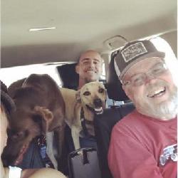 John with his son, Andrew, and his daughter, Colleen (shoulder), and two of their dogs out for a fun day  this past summer.

