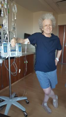 Tethered to the IV pole  wearing a PICC line compatible t-shirt inside out