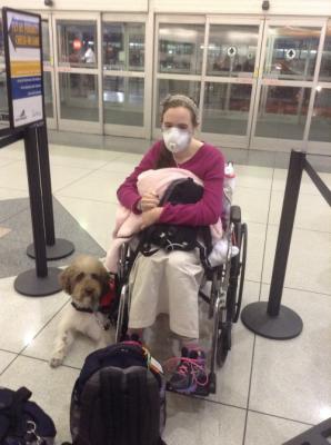 Waiting to go through security and board the plane {me in a manual wheelchair, Ezra lying beside me, and luggage around me}