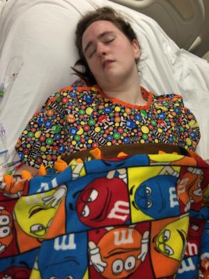 Allison in her M&M hospital gown and blanket that Mom made for her.