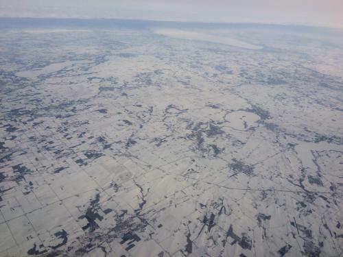 The view of the snow from the airplane.