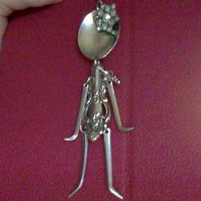 This is the spoon girl i found at the flea market..  She has a snow flake earring as a bow on her head.