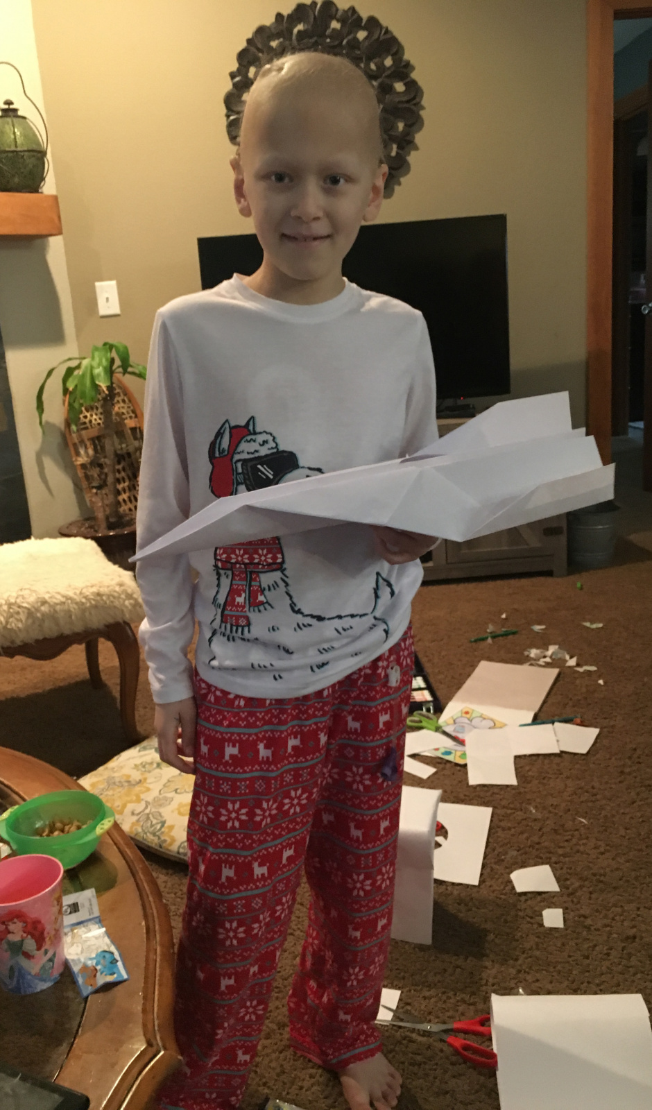 He's so smart! A regular piece of paper wasn't enough, he had to glue four pieces together to make a MONSTER plane. Also, I told him he looks like Bob Ross the way his head is positioned in from of our wall art.