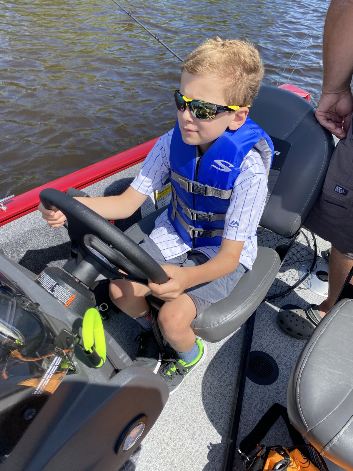 I love this photo so much. He was so proud to be "driving" (in the middle of the river with no obstacles). Note:  the accelerator was off-limits for now... we all wanted to stay in the boat. :).