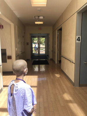 Going in for her final radiation treatment! Ted and Gavin cheering Claire on from outside the treatment wing. 