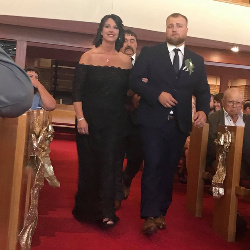 Being escorted down the aisle by her baby boy on his wedding day - September 8, 2018