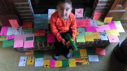 Samuel with some of the many encouraging cards he has received from the kids at church in his Sunday school class.  He really misses going.