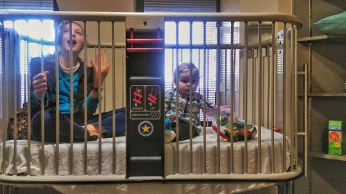 Abi and Rose hanging out the crib in Samuel's infusion room in clinic