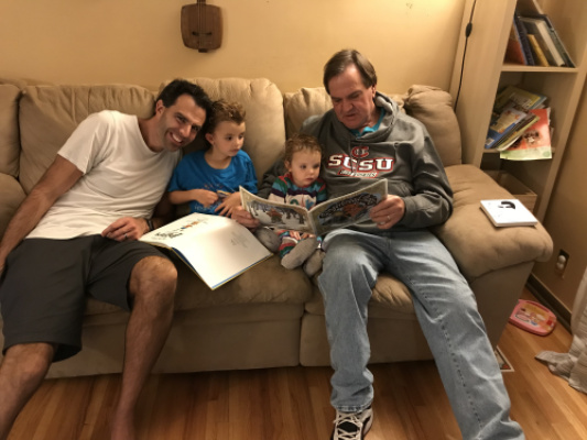 Son Jeff and his two daughters enjoy Papa reading to them 