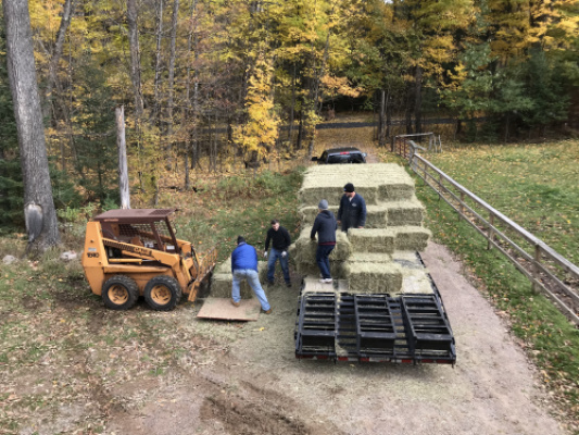 thankful for neighbors helping us unload 200 bales of hay