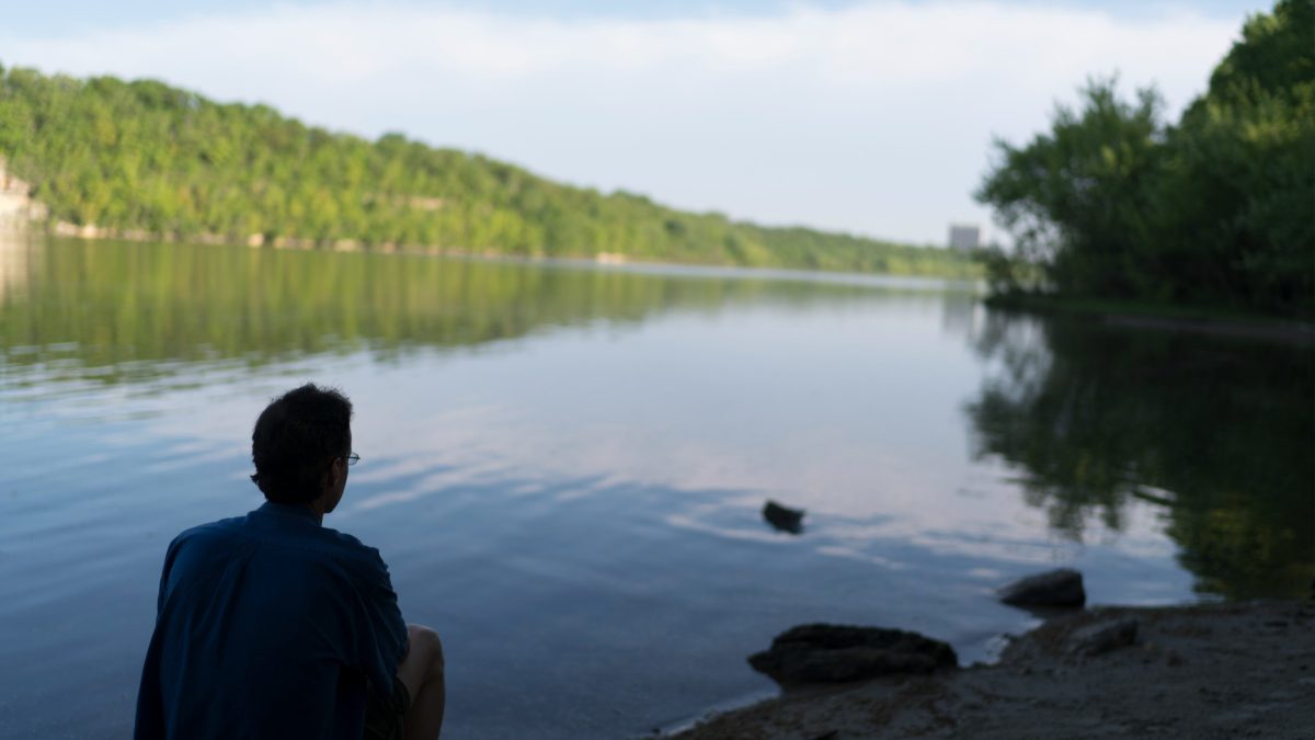 Man sitting by lake