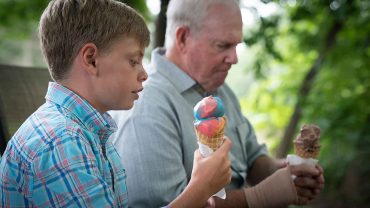 Man and child eating ice cream